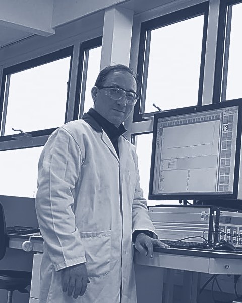 Dr. Kasra Behzad, founder of MicroMetrix, in the lab at an atomic force microscope